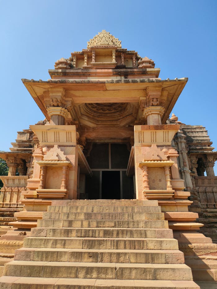 Home Explore the intricate architecture of an ancient temple in Khajuraho, India, showcasing historical artistry.